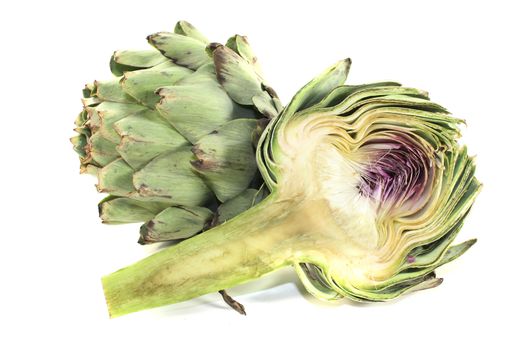 sliced and whole artichokes on a light background