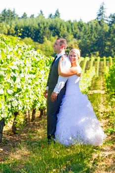 Portraits of a bride and groom outdoors in a vineyard at a winery in Oregon right after their ceremony and vows.