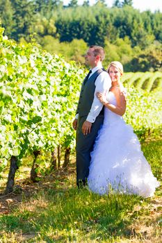 Portraits of a bride and groom outdoors in a vineyard at a winery in Oregon right after their ceremony and vows.