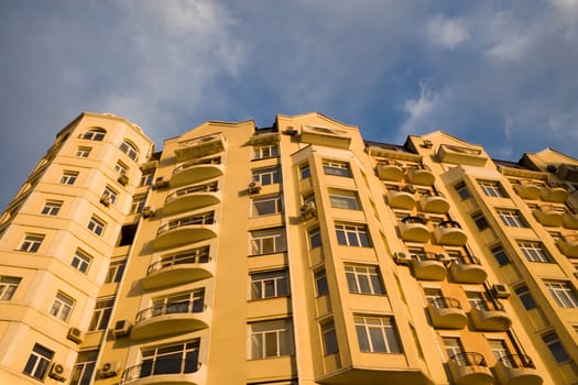 Yellow building on a background of the blue sky.