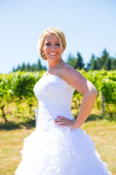 A beautiful bride wearing her wedding dress on her special day at a vineyard outdoors in Oregon during the summer.