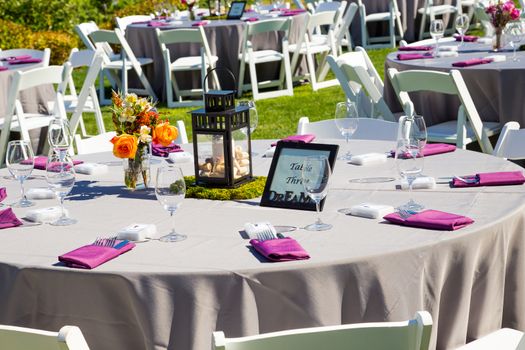 Tables, chairs, decor, and decorations at a wedding reception at an outdoor venue vineyard winery in oregon.