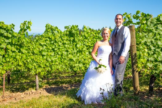 Portraits of a bride and groom outdoors in a vineyard at a winery in Oregon right after their ceremony and vows.