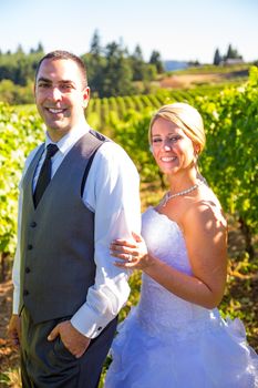 Portraits of a bride and groom outdoors in a vineyard at a winery in Oregon right after their ceremony and vows.