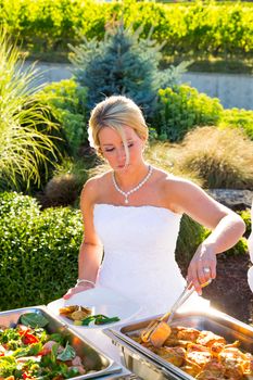 Dinner is served at this beautiful wedding reception outdoors at a vineyard.