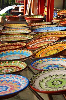 Traditional Bulgarian hand-painted ceramic plates used for serving food are popular tourist souvenirs