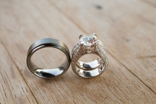 The rings of a bride and groom are photographed with a macro lens to show the closeup detail of these fine pieces of jewelry.