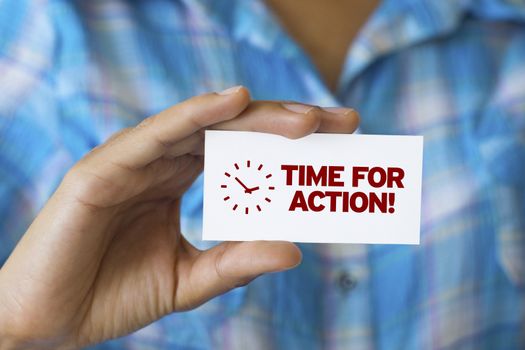 A person holding a white card with the words Time For Action