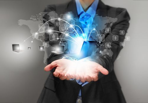 Image of business person holding devices in hands