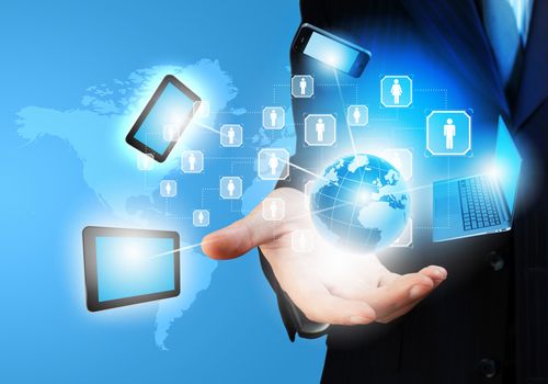 Image of business person holding devices in hands