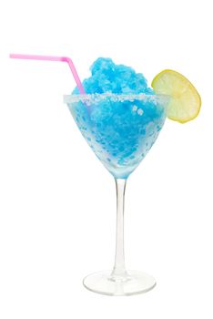Frozen crushed ice blue cocktail with slice of lime and straw 