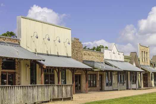 A row of old western rural shops with a bright blue sky in the background.