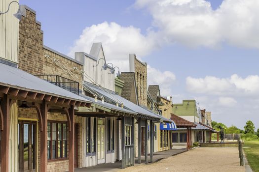 A row of old western rural shops with a bright blue sky in the background.