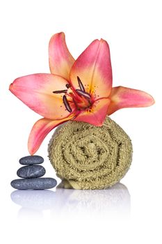 Lily, towel and spa stones on white background. Spa concept. Macro shot