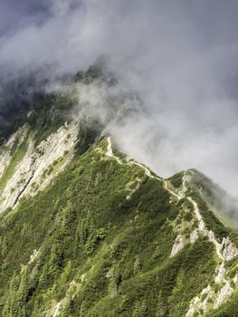 Hiking on a ridge of the mountain Herzogstand to the mountain Heimgarten in Bavaria, Germany