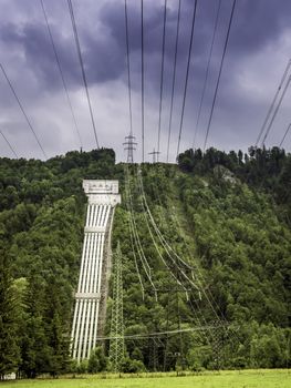 Tubes of a hydroelectric power plant on the hill with trees on Lake Kochelsee, Bavaria, Germany