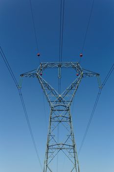 Detail of electricity pylon against blue sky 