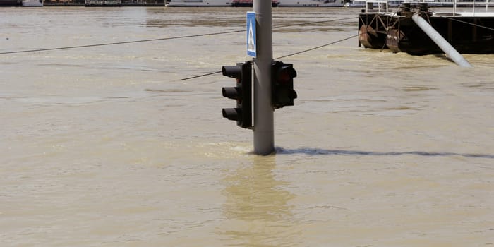 traffic light on flooding river