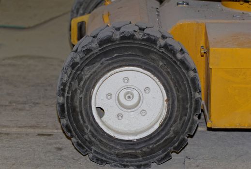 Yellow industrial machine with solid rubber wheel