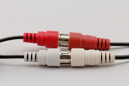 correct conection between left - right audio RCA cable on a white background (red white)