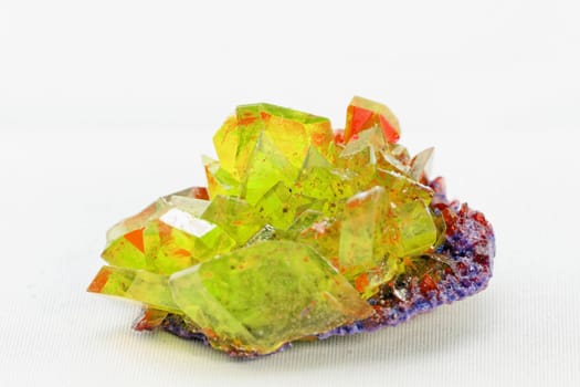 Close up picture about a crystal with topaz color on white background (yellow crystal)