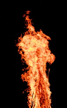 red flames of huge bonfire or campfire as black backgorund