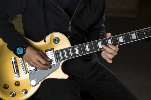 A guitarist playing with a electric guitar. 