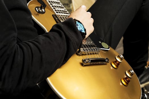 A guitarist playing with a electric guitar.