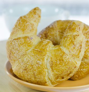 close up fresh  croissants on  brown dish