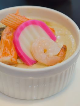 chinese steamed egg with seafood in white bowl
