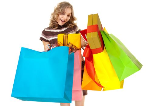 Studio shot of young woman hodling colourful shopping bags with gifts