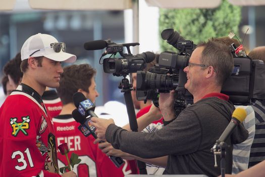 PORTLAND, OREGON - MAY 14: Portland Winterhawks Ice Hockey Team members being interviewed by Television Station at Pioneer Square Rally on May 14, 2013, after winning the Western Hockey League Championship and bringing home the Ed Chynoweth Cup