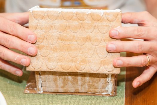 Making gingerbread house together at home before Christmas.