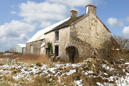 Derict farm building in South Wales, UK. Snow on ground.