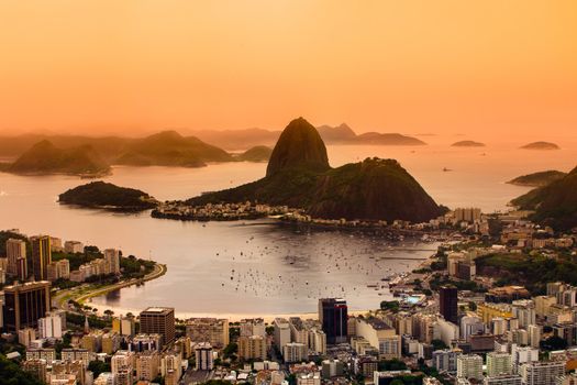 Rio de Janeiro, Brazil. Suggar Loaf and  Botafogo beach viewed from Corcovado at sunset.