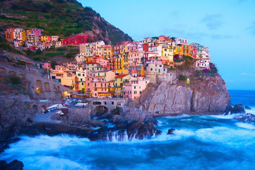 Manarola fisherman village in a dramatic wind storm. Manarola is one of five famous villages of Cinque Terre (Nationa park), suspended between sea and land on sheer cliffs upon the wild waves.