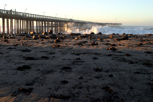 Ocean waves throughout at storm crashing into the Ventura pier.