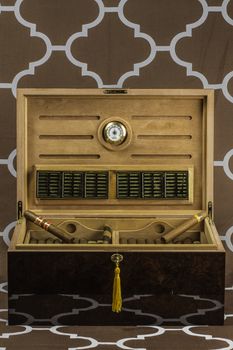 A large cigar humidor showing off a selection of smokes with the lid open.