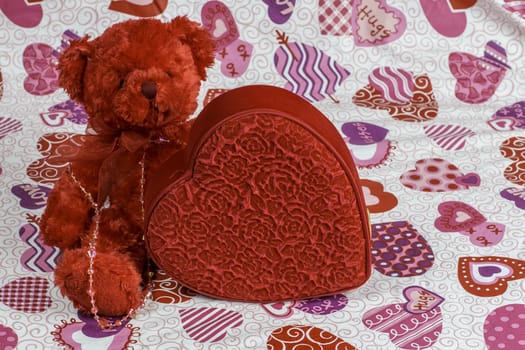 A red bear and heart create a colorful Valentine's Day theme.