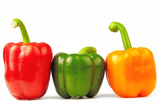 Three multi-colored paprikas on the white isolated background