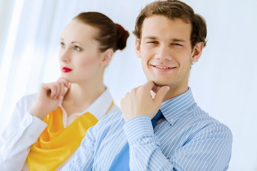 Image of businessman and businesswoman smiling joyfully