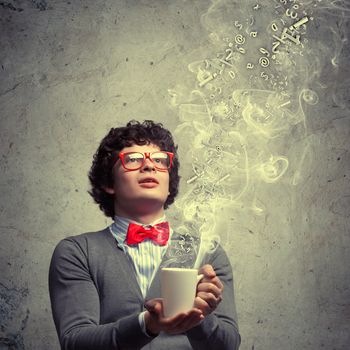 Young man with smoke coming out of a cup experimenting