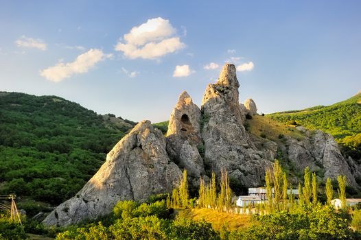 Rock surrounded by green mountains