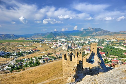 The site of the fortress wall overlooking a small town.