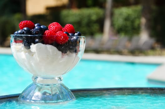 Morning dessert with fresh berries by the swimming pool