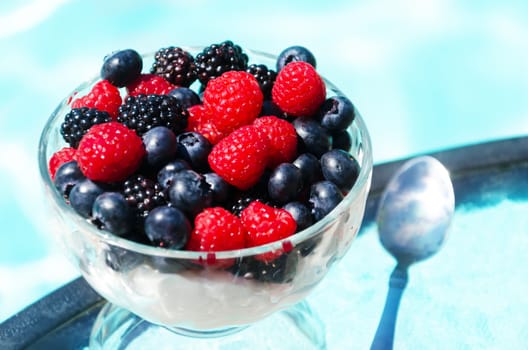 Morning dessert with fresh berries by the swimming pool