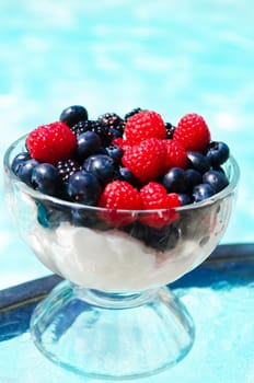 Morning dessert with fresh berries by the swimming pool