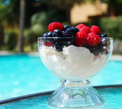 Morning dessert with fresh berries by the swimming pool