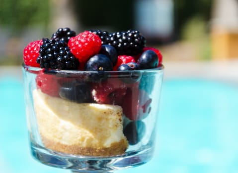 Morning dessert with fresh berries by the swimming pool