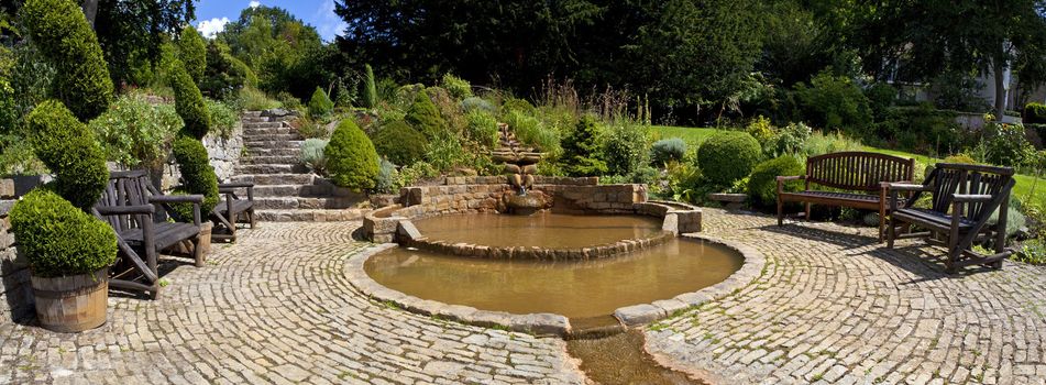 Panoramic shot of the Vesica Pool in the Chalice Well Gardens in Glastonbury.
